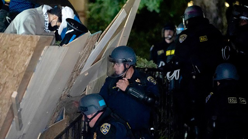 Danilo Perez also won first place in the JACC news photo category for this image of a California Highway Patrol Special Operations Unit attempting to take down the barrier leading into a pro-Palestinian encampment on Dickson Court at UCLA on Wednesday, May 1, 2024 in Los Angeles, Calif. (Photo Credit: Danilo Perez | The Corsair)