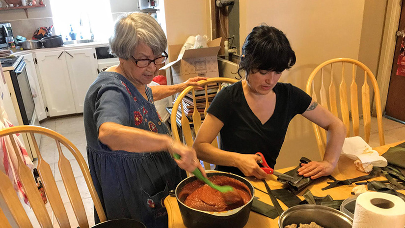 Ana making tamales with her grandmother