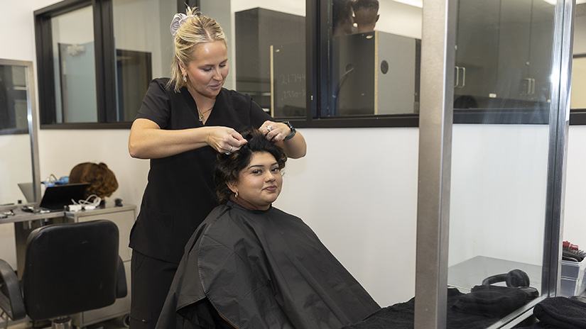 Student setting a client's hair.