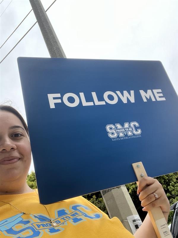 staff member holding a sign