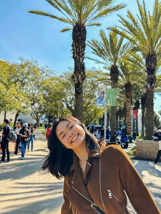 student smiling in sunlight