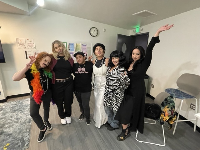 Group of attendees posing in Drag makeup with Johnny Gentleman